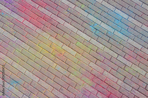 Multi colored paving slabs, powder coated with dry colors at the Holi festival photo