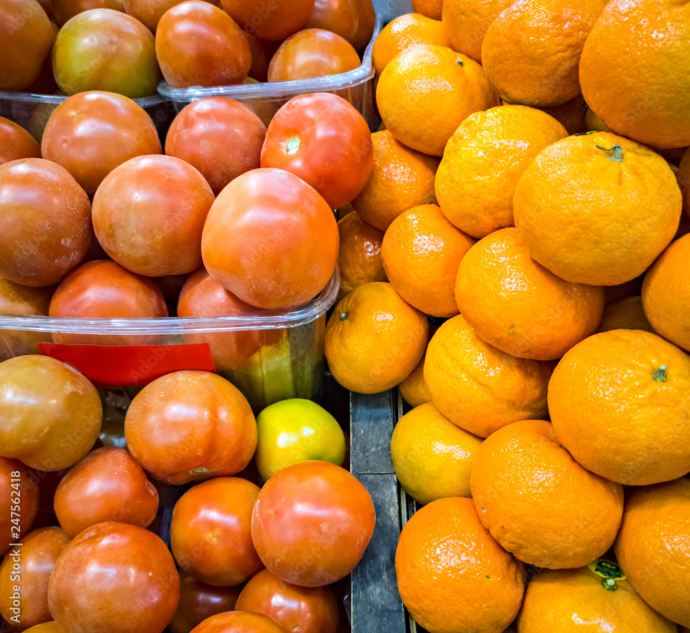 Piles of fresh vegetables and fruits on a market place