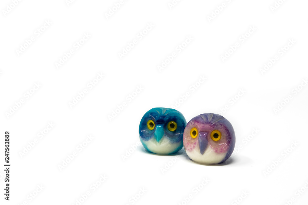 Lucky owl ornament. Small glass lucky object, charm. Blu, azzurro, lilla, viola, giallo. Isolated on white background. Tradition has it that a pair (couple) of owls bring luck. Lucky owl ornament. Small glass lucky object, charm. Blu, azzurro, lilla, viola, giallo. Isolated on white background. Tradition has it that a pair (couple) of owls bring luck.