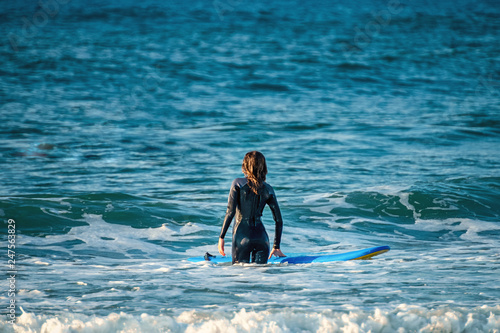 12/18/2018 Netanya, Israel, a surfer with a board goes swimming in the ocean at the dawn of the day