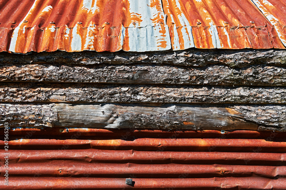 Foto de Rusty corrugated metal sheet roofing and pine wood; both