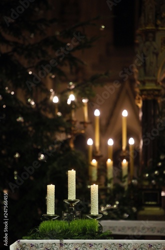 Burning candles on church altar photo