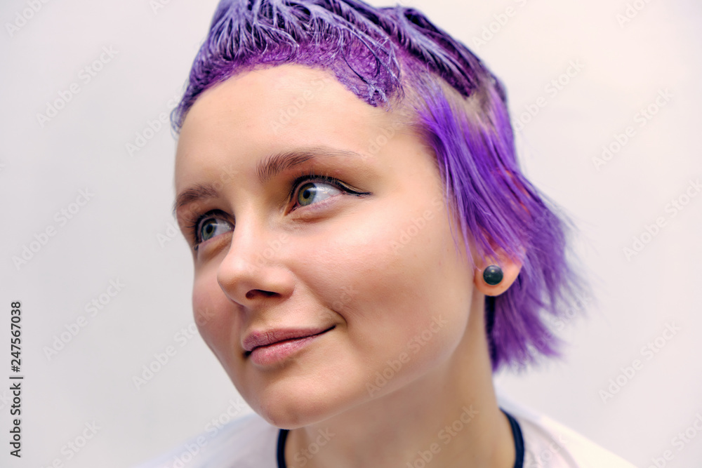 Beautiful girl with violet hair on white background master in make-up. Beautiful girl with violet hair on white background master in make-up.