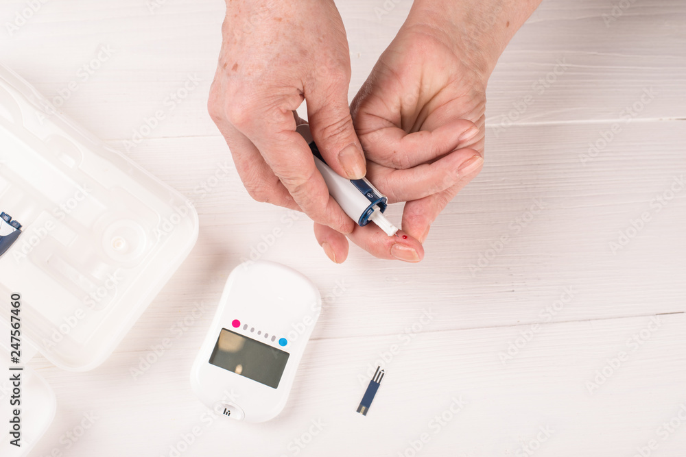 Sugar test for diabetics, close-up of the arm and a drop of blood Sugar test for diabetics, close-up of the arm and a drop of blood