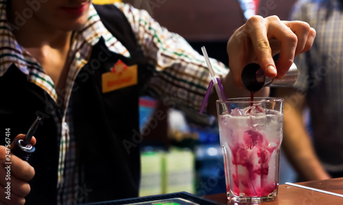 waiter serving champagne ckctail with berries at a party