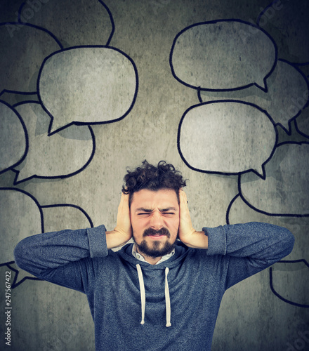 Принти на полотні stressed man covering with hands his ears tired of too much talk