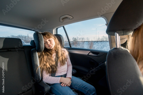Sleeping little girl in child car seat during long journey © leszekglasner