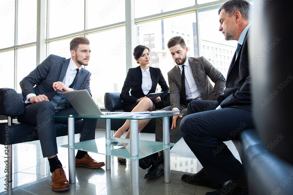 Corporate business team meeting in a modern open plan office Corporate business team meeting in a modern open plan office