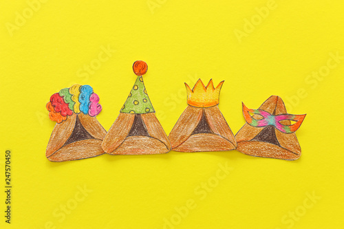 Purim celebration concept (jewish carnival holiday). Traditional hamantash cookies cutted from paper and painted.