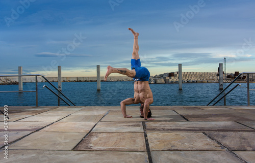 Man performing advanced yoga exercises and stretching.