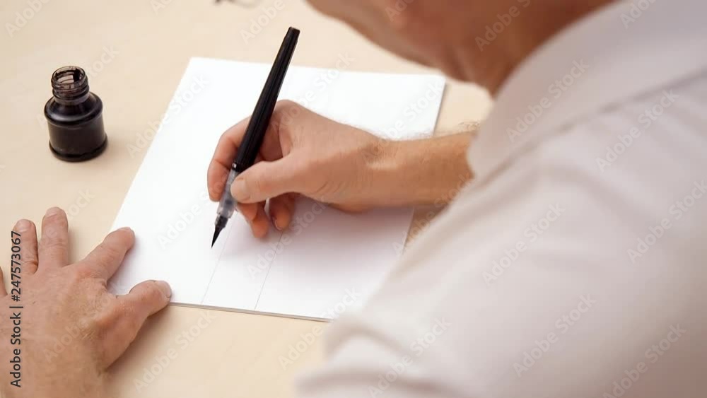 A Man Riting A Letter Man writing a letter on white blank. Close shot. Top view. Calligraphic ...