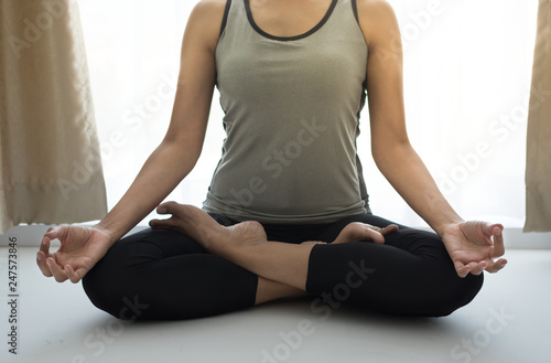 female doing Yoga meditation at home.