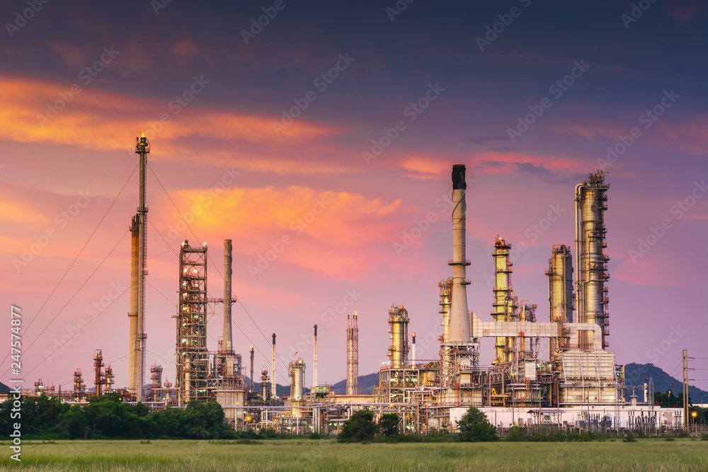 Landscape of oil and gas refinery manufacturing plant., Petrochemical or chemical distillation process buildings., Factory of power and energy industrial at twilight sunset., Engineering petroleum.