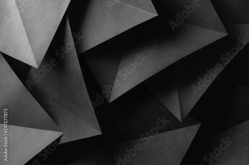 Triangular shapes of gray paper for dark abstract background