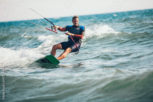 Photos Professional kiter makes the difficult trick on a beautiful background