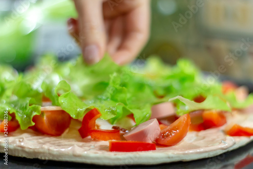 Food ingredients for pizza on table close up, cooking homemade pizza with fresh vegetables
