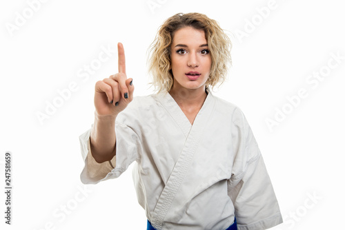 Portrait of female wearing martial arts uniform making idea gesture
