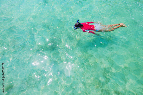 Girl snorkeling in the water of sea