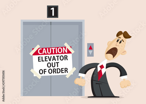 Unhappy businessman standing next to Elevator out of order with caution sign