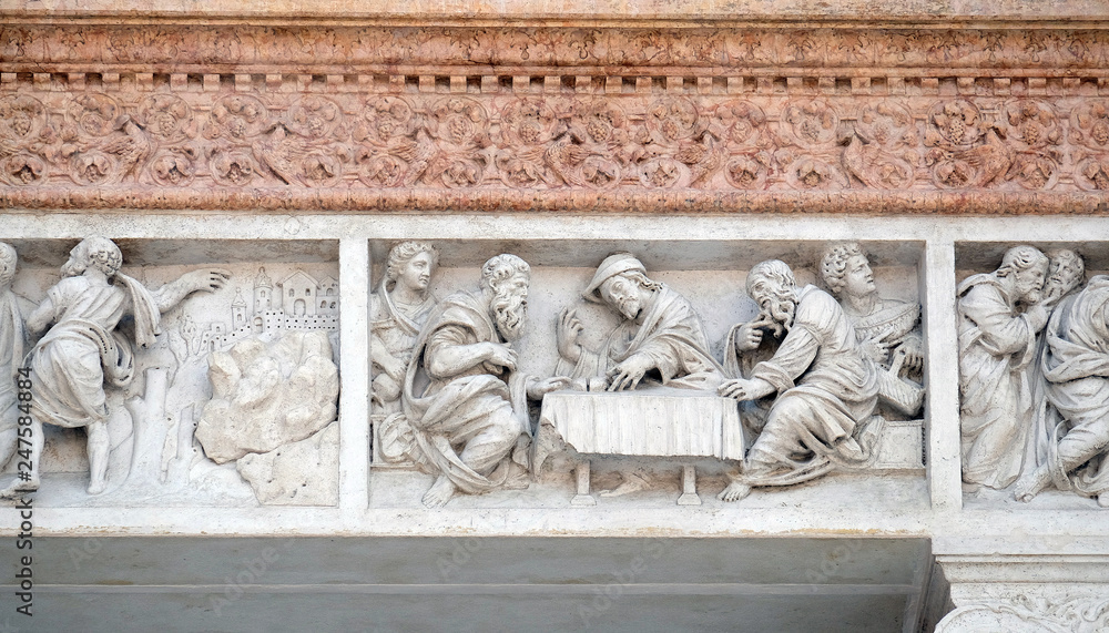 Supper at Emmaus by Zaccaria da Volterra, door of San Petronio Basilica in Bologna, Italy