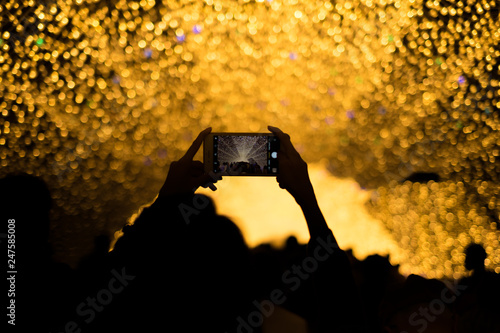Nagoya, Japan-March 15, 2018, Taking a photo with smartphone at Nabana No Sato Spring Illumination, Nagashima spa land, Nagoya, Japan.