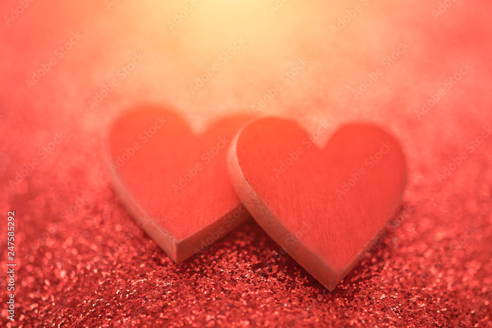 Two red hearts on glitter background in love concept Two red hearts on glitter background in love concept