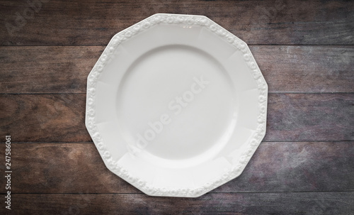 empty dinner plate on wooden table background