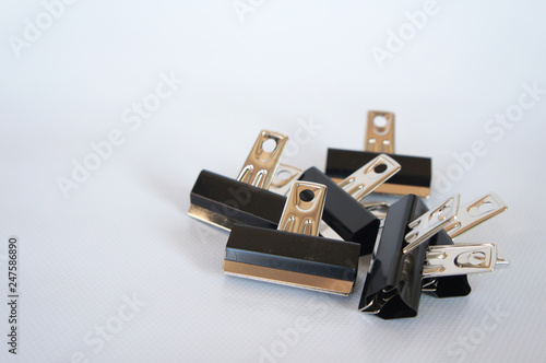 Black color bulldog clip isolated on white background. 