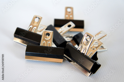 Black color bulldog clip isolated on white background.  photo