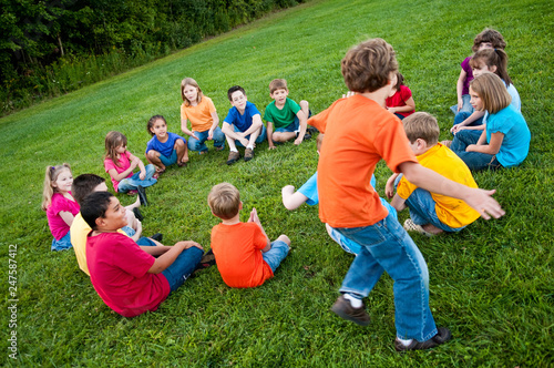 Group of Kids Playing a Game in a Circle Outside photo