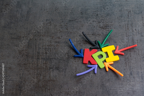 KPI, Key Performance Indicator business target or score to measure success in marketing campaign concept by multiple arrow pointing to colorful alphabet KPI at the center