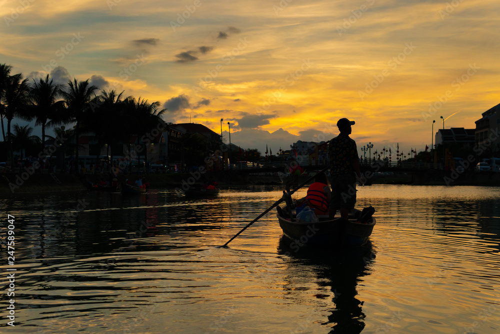 Man in a boat under sunlight in silhouette