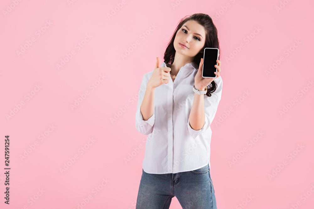 beautiful woman showing smartphone with blank screen and thumb up, isolated on pink beautiful woman showing smartphone with blank screen and thumb up, isolated on pink