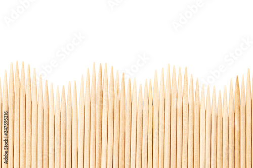 Bamboo toothpicks are placed in parallel - backgrounds, textures. Bamboo toothpicks isolated on white background photo