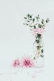 Bouquet of flowers in glass vase isolated on white. Vertical photo