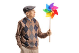 Senior man holding a spinning pinwheel and looking at it