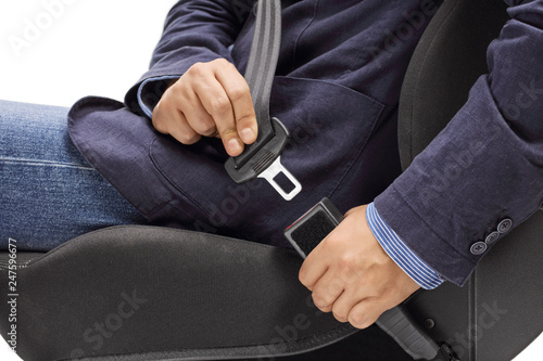 Male hands fastening a car seat belt for road safety