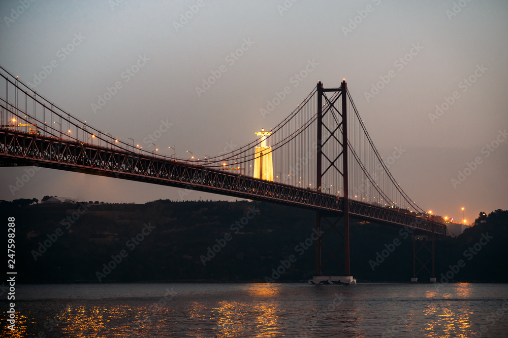 Fototapeta premium 25 april bridge landscape and Christ the King in Lisbon, Portugal