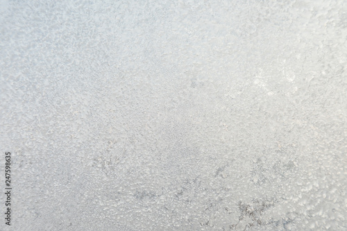 The background or texture of the hoar or rime on the window glass in the cold winter weather