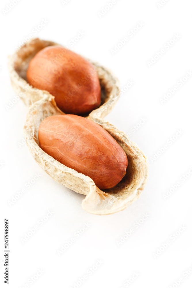 Peanuts on a peeled cob, two grains isolated on white background Peanuts on a peeled cob, two grains isolated on white background