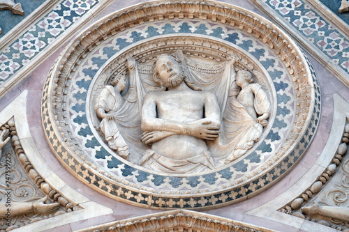 Wrapping Christ in his shroud, Portal on the side-wall of Cattedrale di Santa Maria del Fiore (Cathedral of Saint Mary of the Flower), Florence, Italy