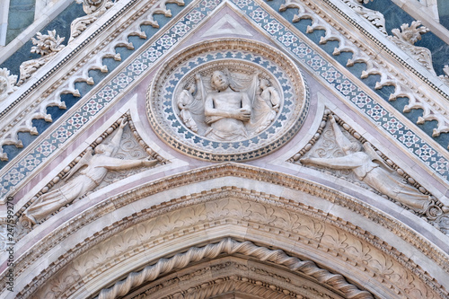 Wrapping Christ in his shroud, Portal on the side-wall of Cattedrale di Santa Maria del Fiore (Cathedral of Saint Mary of the Flower), Florence, Italy