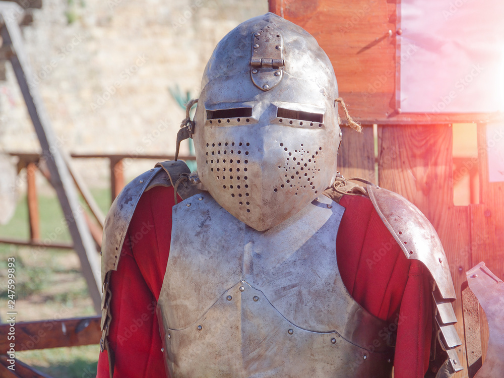 Naklejka premium knight's armor in the sun in the summer outdoors