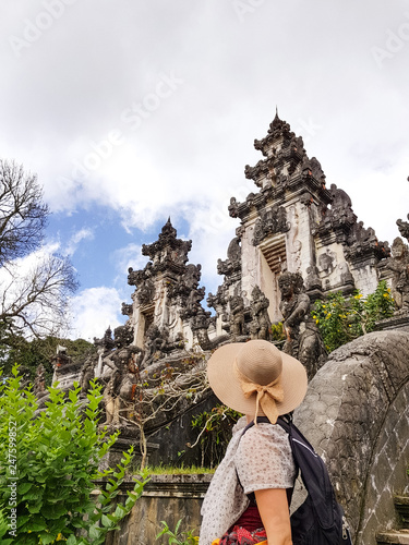 Female tourist with hat at Lempuyang temple photo