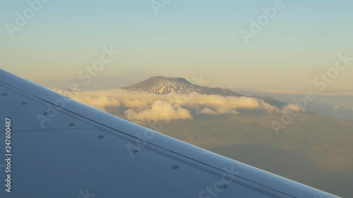 Flying over Mount Etna. Mount Etna is an active stratovolcano on the east coast of Sicily, Italy, in the Province of Catania, between Messina and Catania. It is the largest active volcano in Europe. photo