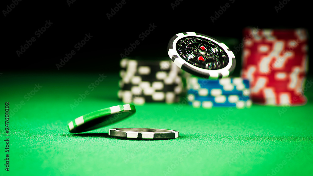 Gambling concept, scattered chips on a green gown