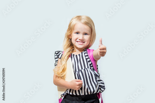 Little child girl beautiful fashionable and happy on isolated background, back to school