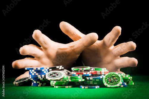 Gambling concept, stack of chips on the background of striped hands