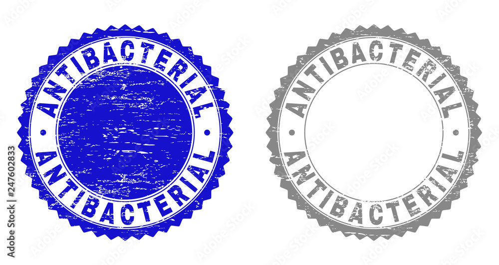 Obraz premium Grunge ANTIBACTERIAL stamp seals isolated on a white background. Rosette seals with grunge texture in blue and gray colors. Vector rubber watermark of ANTIBACTERIAL label inside round rosette.