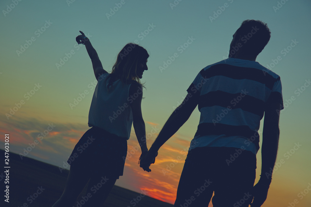 Silhouettes of a couple in sunset / sunrise time. Silhouettes of a couple in sunset / sunrise time.